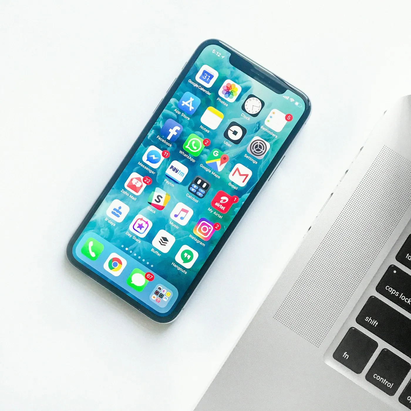 Apple iPhone beside a laptop